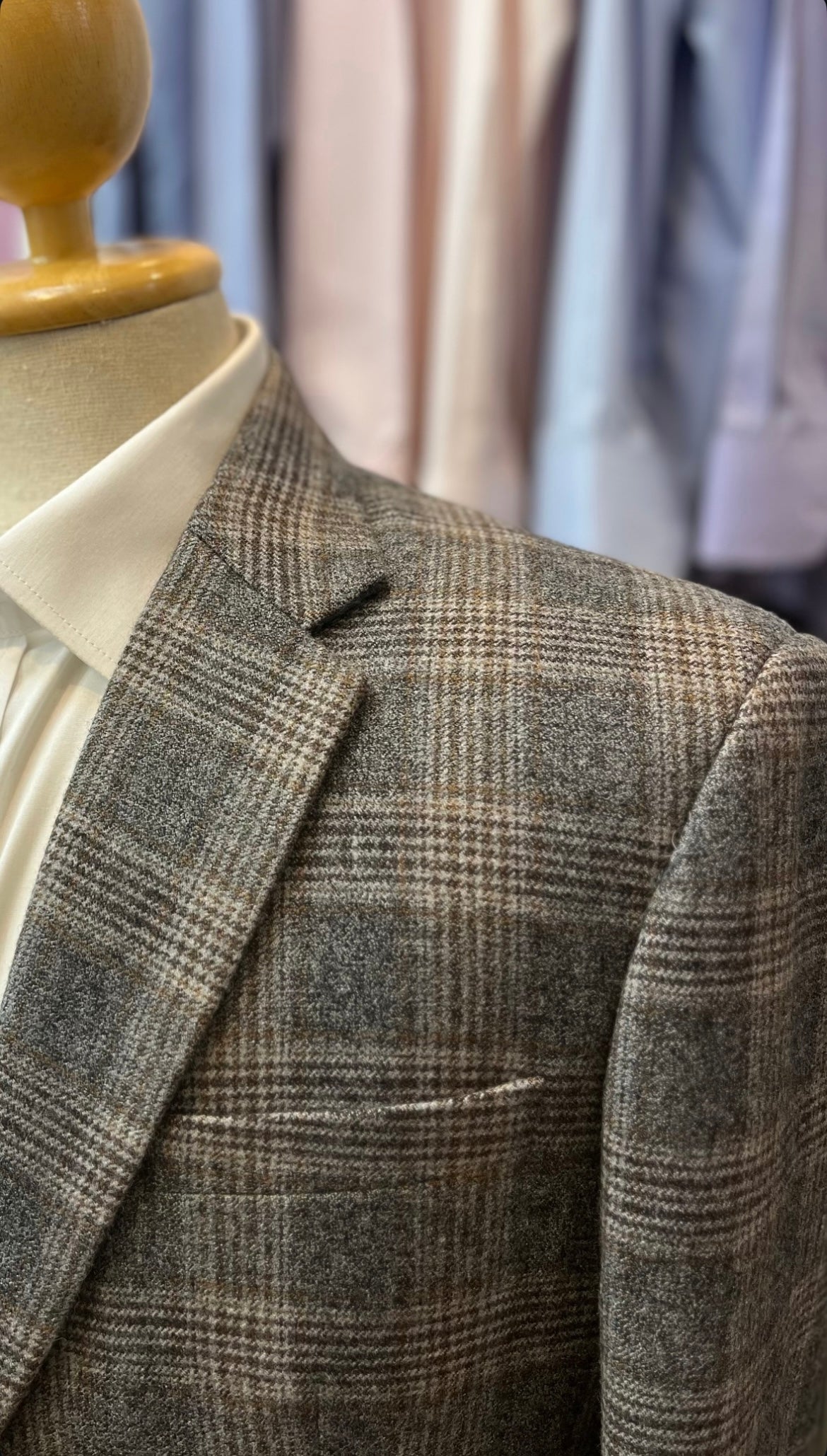 Checked tweed tailored jacket with notch lapels and a cream shirt