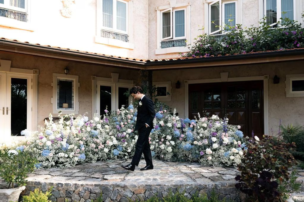Groom wearing a bespoke black suit by Country Road at his wedding