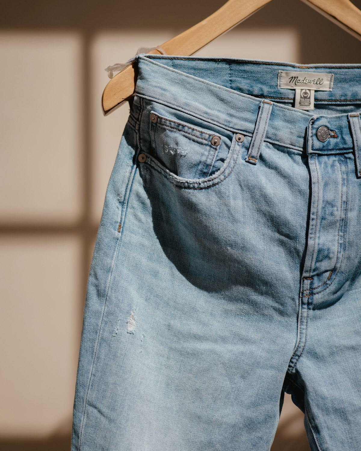 Light wash jeans on a hanger